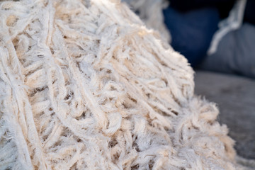 Fabric scraps, old clothing and textiles are cut into strips waiting for recycle.