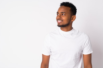 Portrait of happy young handsome African man thinking