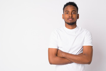 Fototapeta premium Portrait of young handsome African man with arms crossed