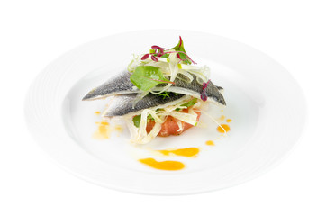 Dorado fish with grapefruit and green salad on a plate on a white background, isolated