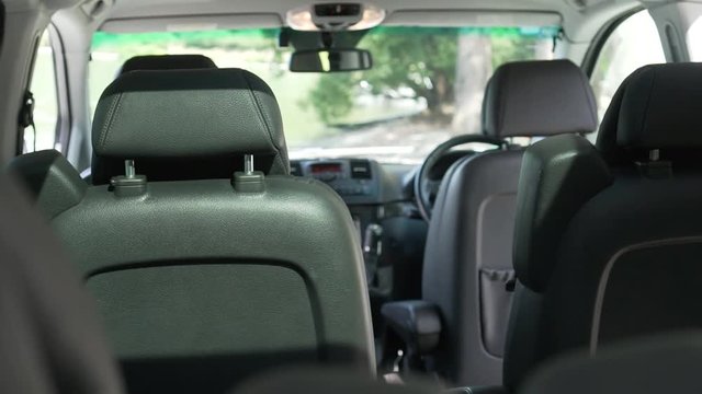 SLOWMO - Interior of luxury minivan black leather seats and cockpit from back to front