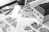 Drawings, layout of the house, documents, calculator on the desktop in the office. Engineering, construction, business.