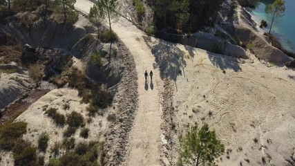 Hiker on a path in summer, drone point of view