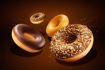 Flying donuts with chocolate glazed, sprinkled nuts and splatters of glaze. Sweet food concept....