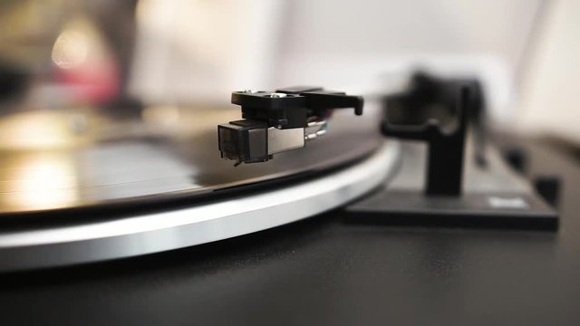 Clear vinyl spinns on the turntable, the headshell moves over the vinyl, drops down on the vinyl and the record begins to play