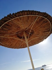 beach straw umbrella against the sky. outdoor