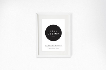 A4 white portrait frame on white wall