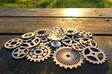 small crystal globe in front of sunset. travel and global issues concept