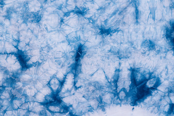 Pattern of blue dye on cotton cloth, Dyed indigo fabric background and textured