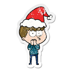 distressed sticker cartoon of a curious boy wearing santa hat