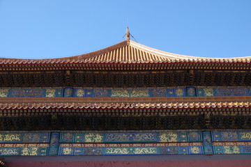 Fototapeta premium Tiled roof and facade decorated with a Chinese pattern. Palace in The Forbidden City, Beijing, China.