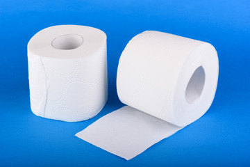 Two rolls of toilet paper isolated on blue background