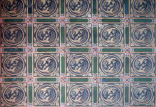 An ornate painted ceiling on a building in the Forbidden City in Beijing, China