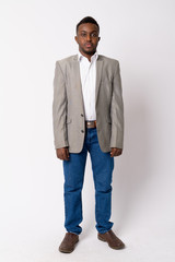 Full body shot of young African businessman in suit