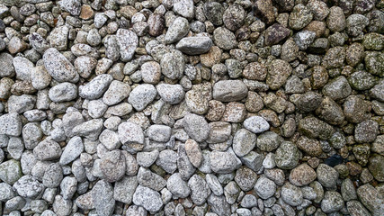 White rock were sprinkled on ground which is Japanese stone garden style Beside it is the part of the water that drips down and causes the rock to form lichen.