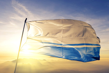 Altai Republic of Russia flag waving on the top sunrise mist fog