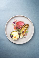 Barbecue wagyu point steak from beef sliced with chicory and mashed potatoes as top view on a modern design plate