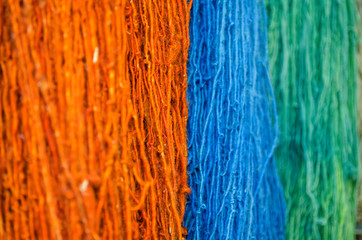 multicolored woolen threads photographed by close-up.