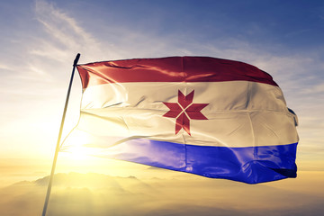 Mordovia Republic of Russia flag waving on the top sunrise mist fog