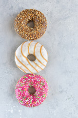 a large Cup of cappuccino coffee and colorful donuts, on the Cup inscription in French (mocha coffee, coffee with milk). light background, selective focus, without logo