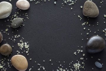 layout on black background sea stones and sea salt with copy space