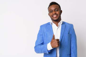 Portrait of happy young African businessman giving thumbs up