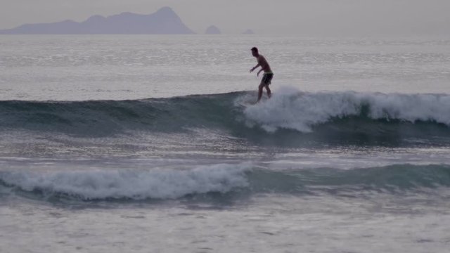 Surfer on Blue Ocean Wave in the Tube Getting Barreled. Surfer riding the waves.