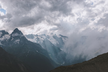 Obraz premium Panorama of mountains scene with dramatic blue sky in national park of Dombay