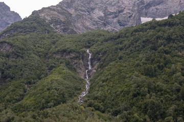 Panorama view on mountains scene and away waterfall in national park of Dombay