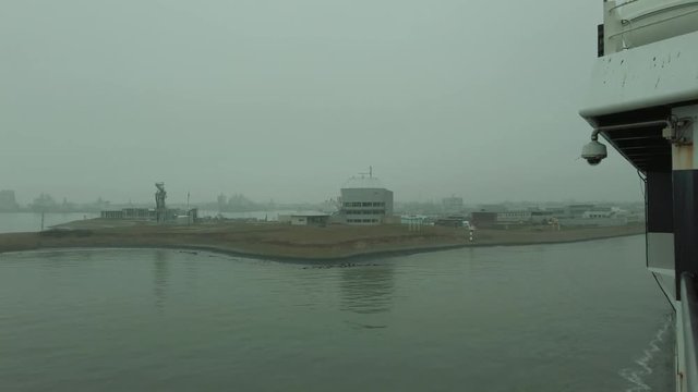 POV shot from a ferry leaving the harbour of Den Helder, Netherlands on an overcast day.