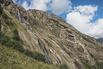 Panorama view of waterfall scene in mountains, national park of Dombay, Caucasus