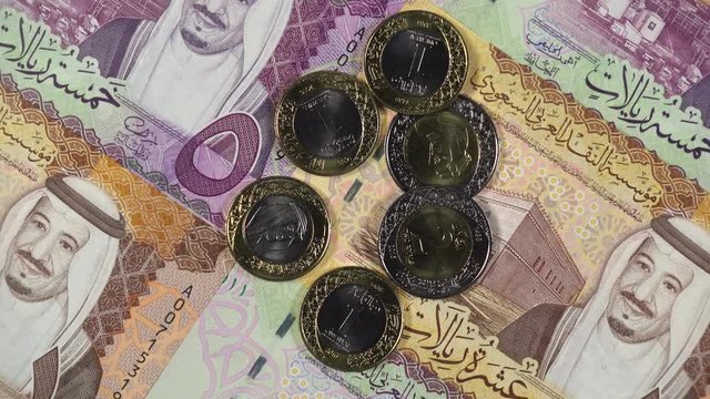Saudi Arabia riyal notes and coins rotating. Saudi Arabian currency, money. 4K stock video footage