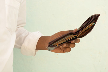Closeup of Man hands showing walltet with currency notes.