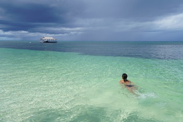 Woman swimming along a beach of Siquijor Island, Philippines