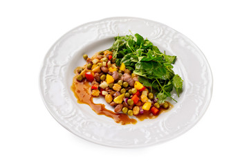 Plate of steamed beans, peas and chickpeas with greens isolated at white background.