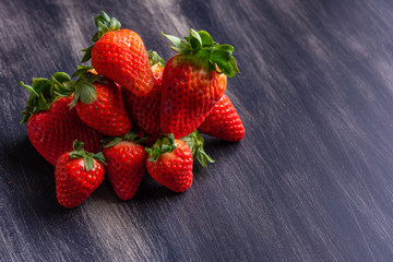 Strawberries on dark wooden background