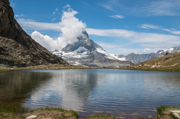 Naklejka na ściany i meble Panorama of Riffelsee lake and Matterhorn mountain in national park Zermatt