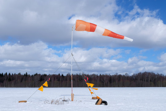 A windsock is on the snowy field.