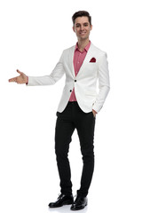 smiling young businessman presenting something to side