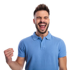 Obraz premium Cheering man wearing a light blue polo feeling excited