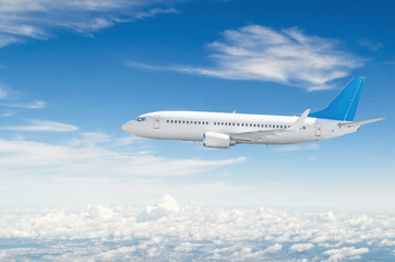 Naklejka na ściany i meble Airplane flies in blue sky cloudscape view.