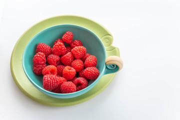 fresh raspberries in a bowl, colourful concept for healthy food