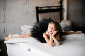 Little girl gymnast, performs various gymnastic and fitness exercises.