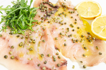 A delicious carpaccio of fresh swordfish, seasoned with extra virgin olive oil, chives and a few drops of lemon juice