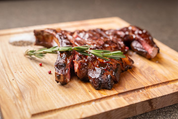 Food and horse meat concept - Roast meat on cutting board with cumin