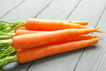 Ripe carrots on wooden background, closeup