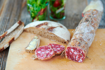 Snack with Italian salami and fresh bread from the oven 