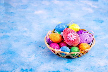 Happy Easter and Lots of bright colored Easter eggs in krasinki on a blue background.