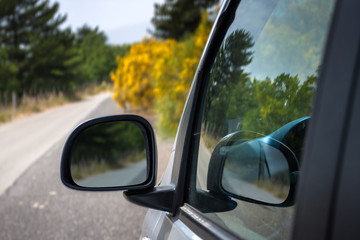 Mirror of the car with the road