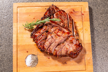 food, delicious and craft concept - cutting horse meat steak on wooden desk